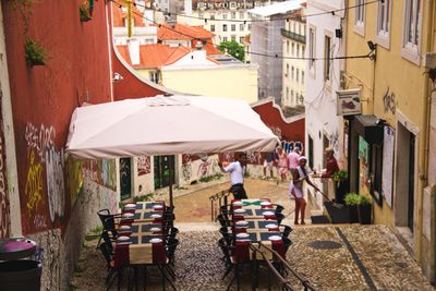 People on street amidst buildings in city