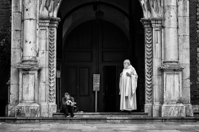 Statue of woman outside historic building