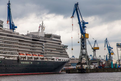 Commercial dock by sea against sky in city