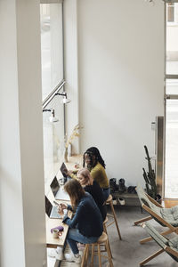 High angle view of businesswomen working together in office