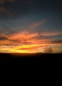 Scenic view of silhouette landscape against sky at sunset