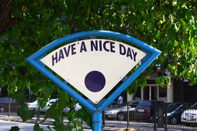 Close-up of road sign against plants