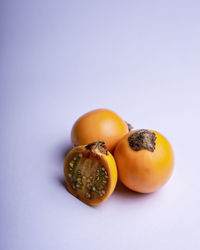 Close-up of orange fruit against white background