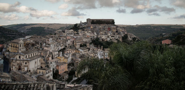 Buildings in town against sky