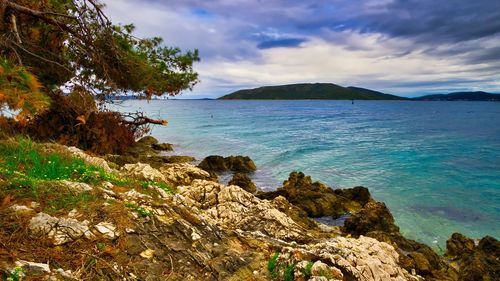 Scenic view of bay against sky