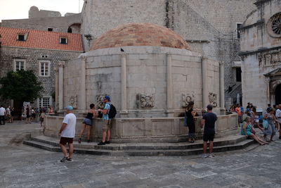 Group of people in front of historic building