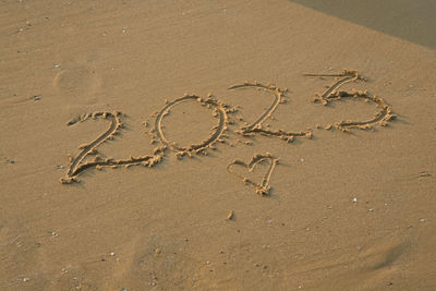 High angle view of footprints on sand at beach