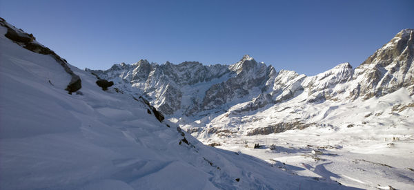 Scenic view of snowcapped mountains against clear sky