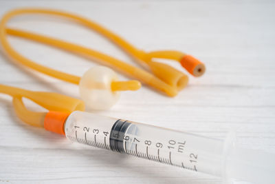 Close-up of syringe on table
