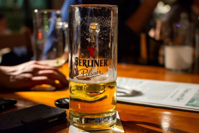 Close-up of beer glass on table