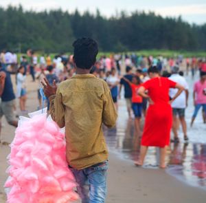 Rear view of people walking in park