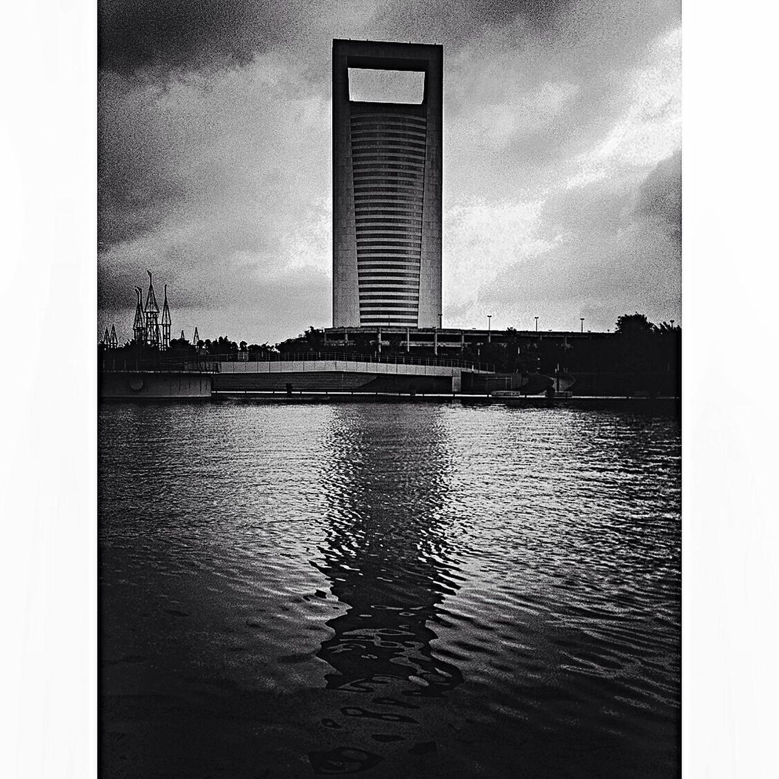 architecture, built structure, transfer print, water, sky, building exterior, waterfront, auto post production filter, cloud - sky, reflection, cloudy, dusk, river, rippled, cloud, overcast, city, silhouette, sea, building