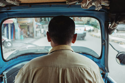 Rear view of man in car
