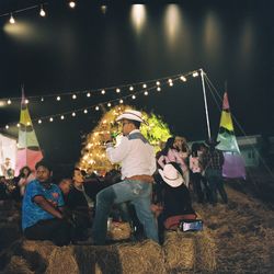 People enjoying music concert at night