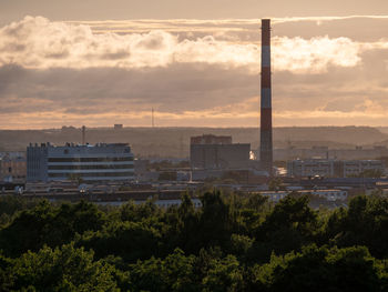 Buildings in city against sky at sunset