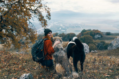 Dogs standing on land against sky