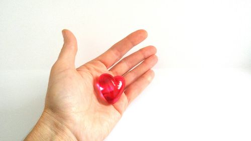 Close-up of human hand over white background