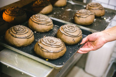 Close-up of hand tray of baked pastry items