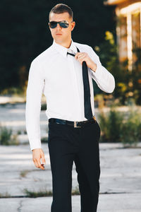 Young man wearing sunglasses standing outdoors