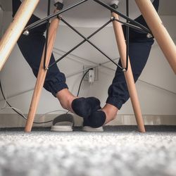 Low section of man lying on rug