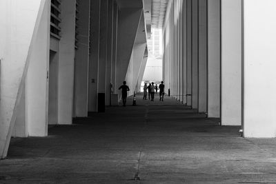 Rear view of man walking in tunnel