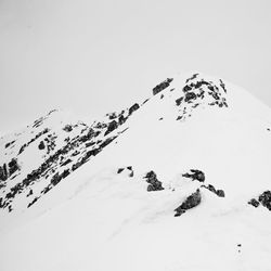 Aerial view of snowcapped mountain against clear sky