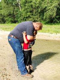 Father embracing son at lakeshore