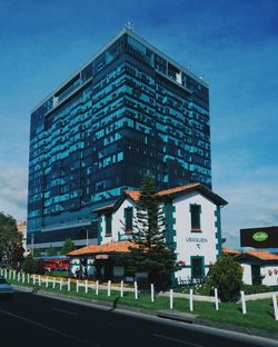 Road by building against sky