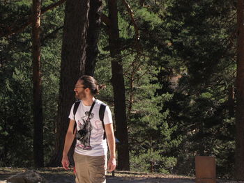 Young woman standing in forest