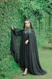 Rear view of woman standing on field