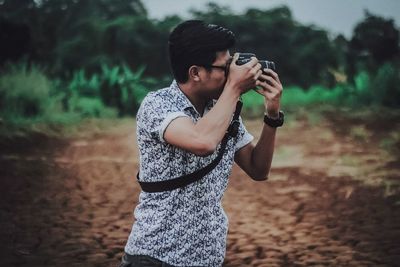 Young man photographing