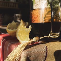 Close-up of half lemon by teapot on table