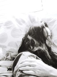 Close-up of woman relaxing on bed