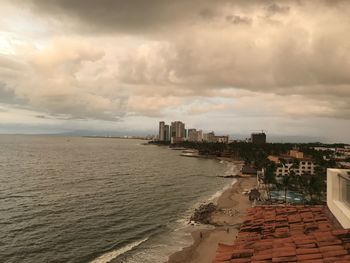 Scenic view of beach and buildings against sky