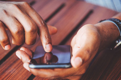 Close-up of man using mobile phone