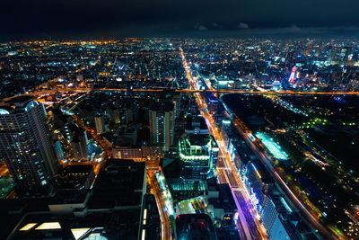 High angle view of illuminated modern buildings in city at night