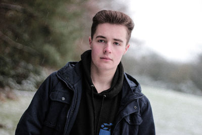 Tilt shot of handsome man during snowfall