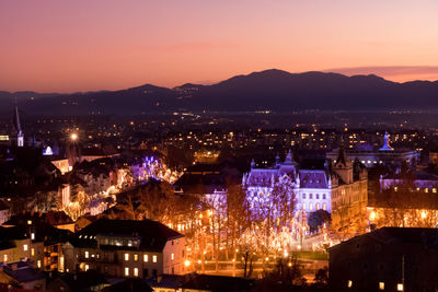 High angle view of city lit up at night