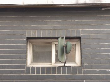 Low angle view of window on wall of building