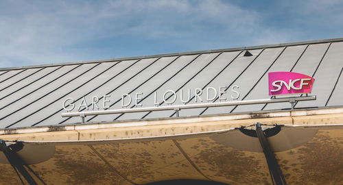 Low angle view of road sign against sky