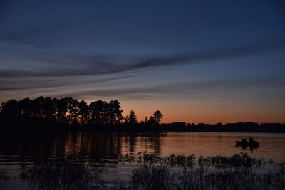 Scenic view of lake against sky at sunset