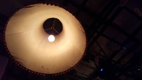Low angle view of illuminated lamp hanging from ceiling