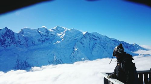 Man by snowcapped mountain