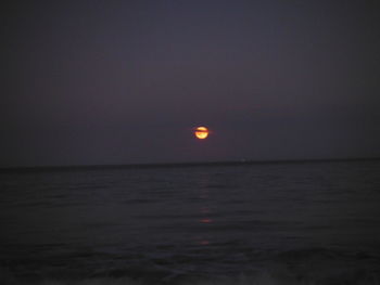 Scenic view of sea against clear sky at night