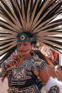 Portrait of man wearing feathers