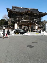 People at temple against sky