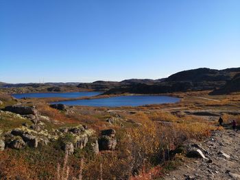 Scenic view of land against clear blue sky