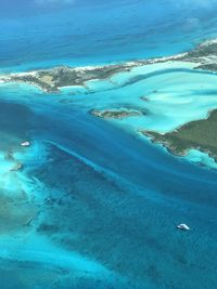 Aerial view of sea against blue sky