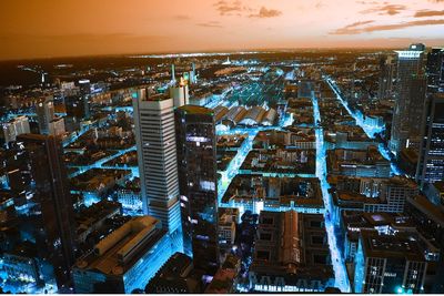 High angle view of illuminated buildings against sky during sunset