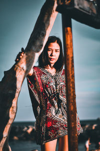 Portrait of a young woman standing outdoors